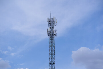 Signal tower or Mobile phone tower .Global connection and internet network concept.on blue sky.