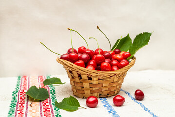 Basket with cherries and leaves on the ornament