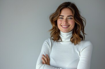Obraz premium Woman With Brown Hair Smiling in White Turtleneck Against White Wall