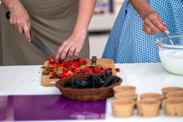 Preparing strawberries for dessert. Background with selective focus and copy space.