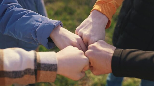 close-up fists a join together team. business team teamwork concept. close-up hands fists together group of people. team of young tourists fists together success business lifestyle concept