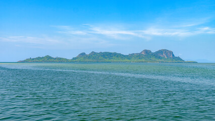Koh Mook or Mook Island with blue sky in Trang. Wide angle view from a boat in the Andaman Sea in the south of Thailand.