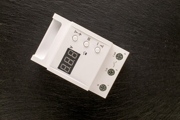 One voltage relay on slate stone, macro.