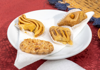 Moroccan sweets, traditional nut-filled pastries, almond desserts, honey cakes plate setup. Moroccan desserts