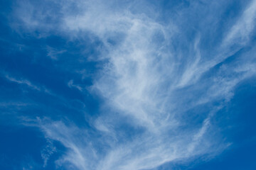 View of thin, wispy cirrus clouds with blue sky. 