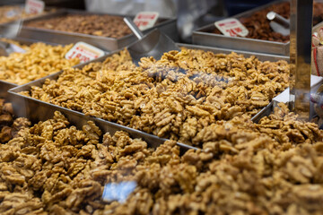 Top view of a pile of big shelled walnuts. Mixed nuts in a nut shop. Selling variety of nuts at the bazar or farmer market