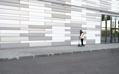Beautiful and blonde girl practicing long board on the road