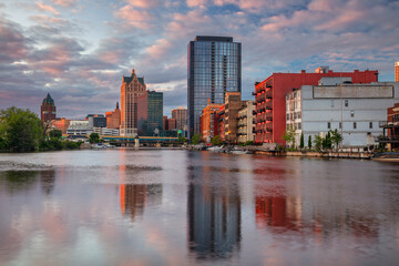 Milwaukee, Wisconsin, USA. Cityscape image of downtown Milwaukee, Wisconsin, USA with reflection of the skyline in Mnemonee River at summer sunset.