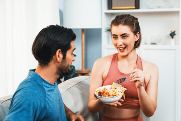 Healthy sporty and vegetarian couple in sportswear with a bowl of fruit and vegetable. Healthy...