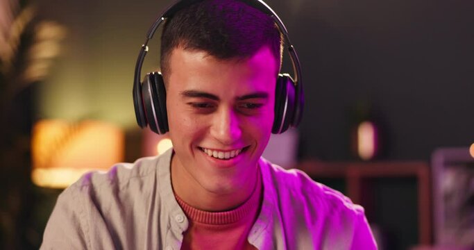 Content creator, headphones and computer with neon, music and media broadcast for web radio host. Audio streaming, musician and man with laptop, internet song and technology with album production