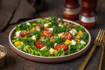 Salad with eggs, cherry tomatoes, dill, lettuce leaves and olive oil. Food for weight loss closeup