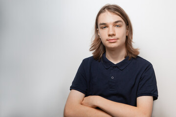Fototapeta premium Portrait of teen boy with long hair on white background