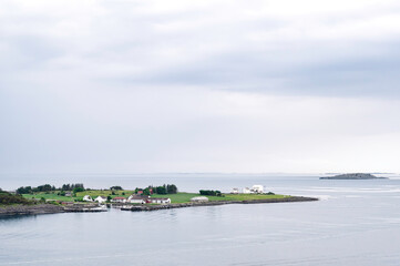 The beautiful, simple coast line near Stavanger, southern Norway.  low lying islands peppered with pretty buildings. Sunrise on a typical spring day