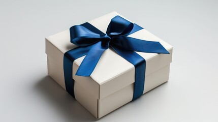 Gift box for the holidays adorned with a blue ribbon against a white background