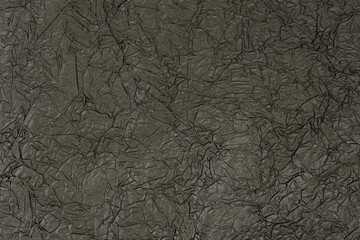 Crumpled matte black paper. Abstrack background, wallpaper. Dark minimalistic background