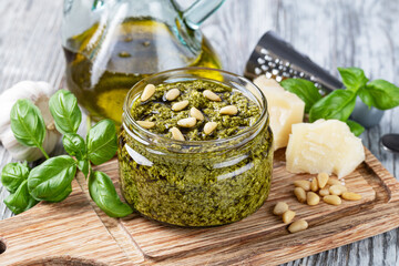 Bowl of basil pesto on wooden table