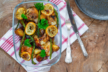 Lemon chicken drimsticks with baked potatoes and asparagus