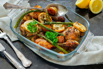 Lemon chicken drimsticks with baked potatoes and asparagus
