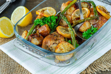 Lemon chicken drimsticks with baked potatoes and asparagus