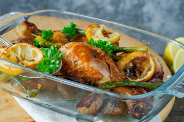 Lemon chicken drimsticks with baked potatoes and asparagus