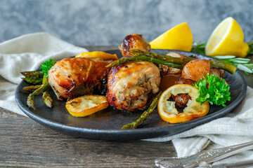 Lemon chicken drimsticks with baked potatoes and asparagus