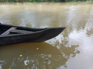 A canoe is a lightweight narrow water vessel, typically pointed at both ends and open on top, propelled by one or more seated or kneeling paddlers facing the direction of travel and using paddles.