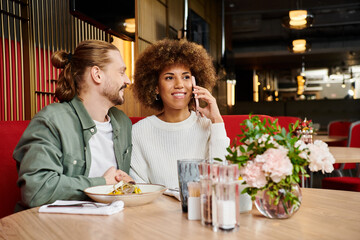 An African American woman and a man at a modern cafe table