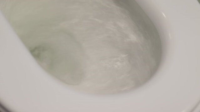 toilet flush.  Close-up flushing water in clean toilet bowl. flushing in a commode