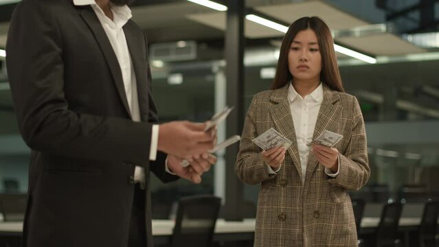 Gender wage inequality between male and female money earning diversity colleagues company business discriminate equal rights problem corporate discrimination man Asian woman count salary oppression