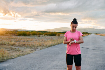  Woman Analyzing Workout Data on Smartwatch Post Run.