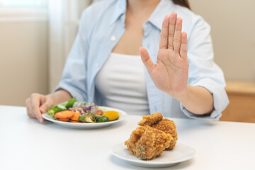 Diet, Dieting asian young woman hand push out, reject fried chicken on plate, deny to eat fast, junk food choose green vegetable salad, girl eat low fat for good healthy, getting weight loss people.