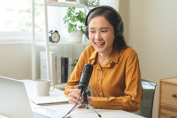 Podcast concept asian young woman radio host work with headphones, microphone while talk,...