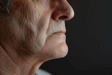 Obraz premium Portrait of a man with a serious expression, dark background