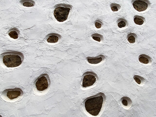 Detail of traditional typical Canarian style wall. White rural facade and black volcanic stones.