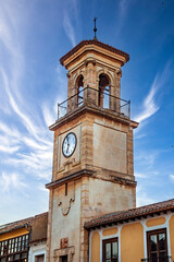 Vertical photo of the beautiful Clock Tower in the monumental Plaza La Mancha in Chinchilla de Montearagon, Albacete, Castilla-La Mancha, Spain.