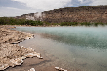 Alolabad geothermal area in Ethiopia with surreal landscape of colorful hot springs, steaming...