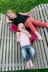Fototapeta premium two little girls friends spend time together in the park