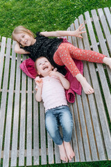 Fototapeta premium two little girls friends spend time together in the park