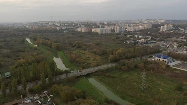 Small river gray old city town 4k aerial view top in autumn. Ukraine building house. Abandoned factory with many ruined buildings. Old brick thick pipe on empty plant. Deserted industrial territory. 
