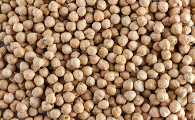 Chickpea background. The chickpeas are poured in an even layer.