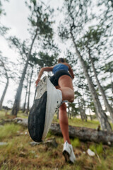 Adventurous Woman Overcoming Forest Obstacles with Determination and Agility.