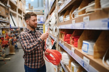 Portrait of happy mature man standing in hardware store © Serhii