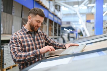 Middle age man choosing floor laminate for his home