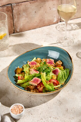 Delicious Tuna Salad with Roasted Potato and Tomatoes in Sunlit Still Life Setting