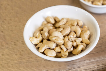 cashews in pot on wooden floor