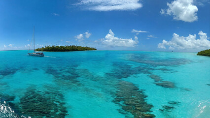 Sailboat anchored off a beautiful Island off the barrier reef, 16:9, 300 dpi, with copyspace