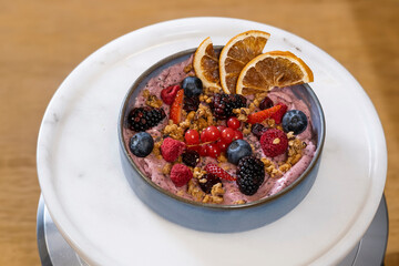 vegan assorted fruit ice cream in container on wooden floor