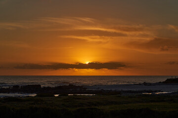 beautiful sunset with golden sunlight over the beaches of Brittany along the coastline of the atlantic ocean in France.