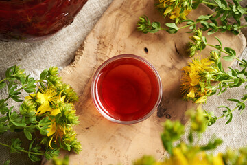 A bowl of red oil made of St. John's wort flowers