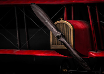 Close up macro of red toy airplane on black background